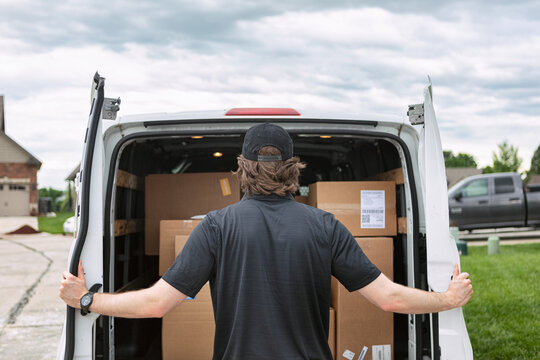 Shipment: Man Opens Rear Doors Of Delivery Van