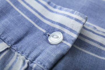 Button on stylish color shirt, closeup