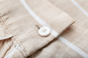 Button on striped shirt, closeup