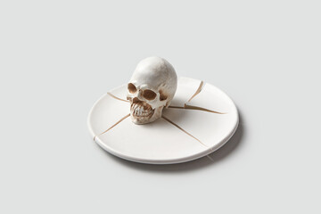 Human skull on broken plate
