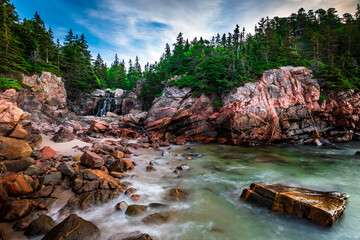 Long exposure waterfall meeting a rocky beach