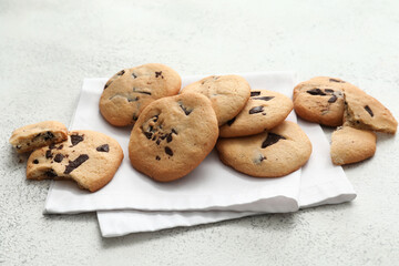Tasty homemade cookies with chocolate chips on light background