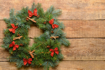 Beautiful Christmas wreath made of fir branches on wooden background