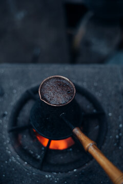 Flat lay - Turkish coffee being cooked in a metal cezve