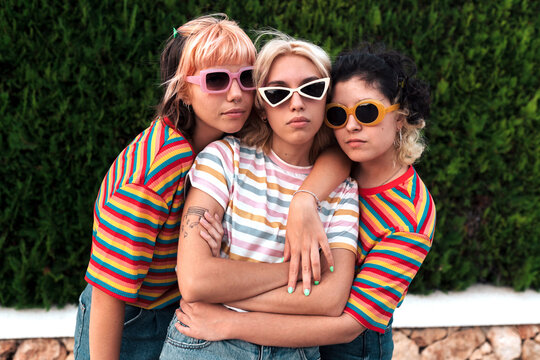 Gen Z women with sunglasses and colorful t-shirts