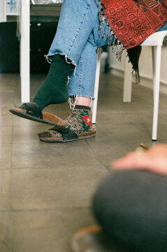 Film photography of feet with unpaired socks