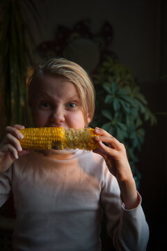 little girl with corn, camera aware portrait