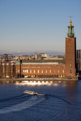 Panorama of Stockholm city on a sunny winter day photographed from the hill. City hall with touristic boat in front. Capital of Sweden