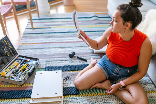 Woman self-assembling furniture 