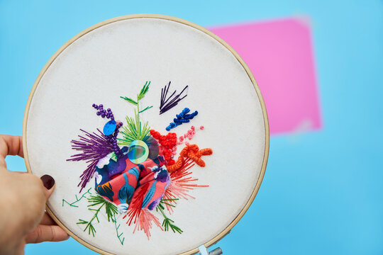 Embroidery on canvas on blue background