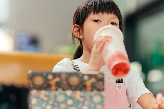 little girl drinks juice