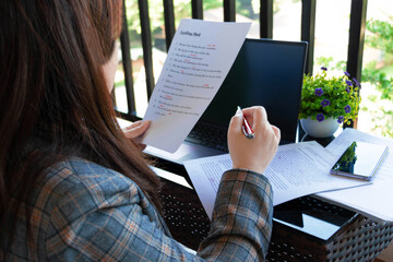 woman's hand working on blurred paperwork
