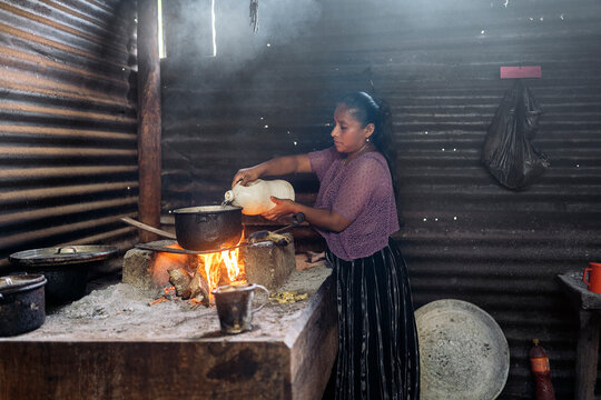 Young guatemalan woman preparing traditional food