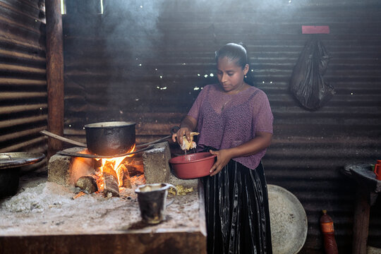Young guatemalan woman preparing traditional food