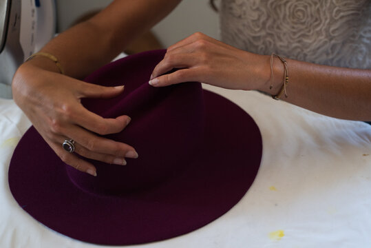 Anonymous artist creating a hat with natural felt