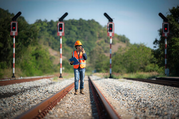 Naklejka premium An Engineer walking on railways with inspection railroad under maintenance period