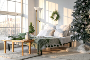 Interior of modern bedroom with beautiful Christmas tree