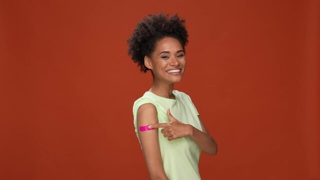 Lady do covid vaccine feedback ok thumb up isolated brick color background