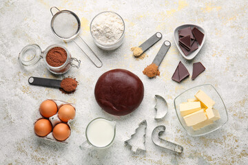 Fototapeta na wymiar Chocolate dough and ingredients on light background