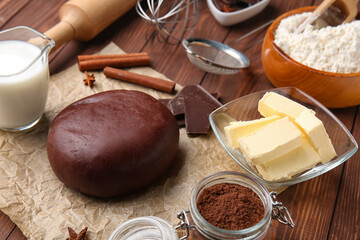 Chocolate dough and ingredients on wooden background