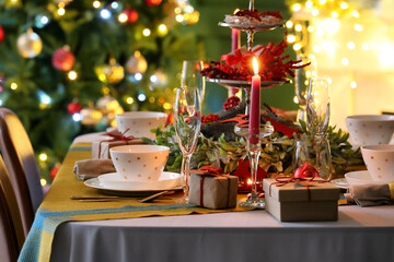 Dining table with beautiful setting in living room decorated for Christmas eve