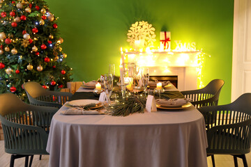 Dining table with beautiful setting in living room decorated for Christmas eve