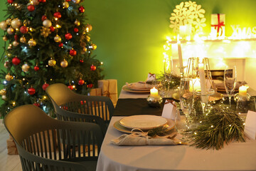 Dining table with beautiful setting in living room decorated for Christmas eve