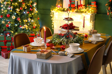 Dining table with beautiful setting in living room decorated for Christmas eve