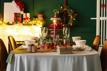 Dining table with beautiful setting in living room decorated for Christmas eve