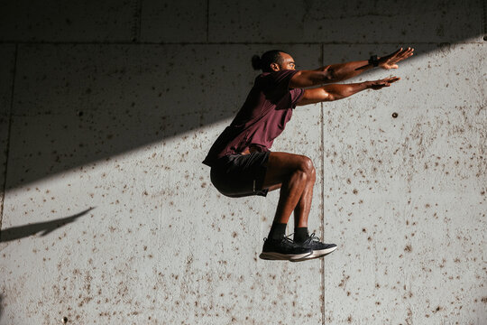 African American male athlete leaping up