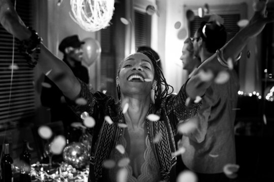 NYE: Excited Woman Throwing Confetti In Air
