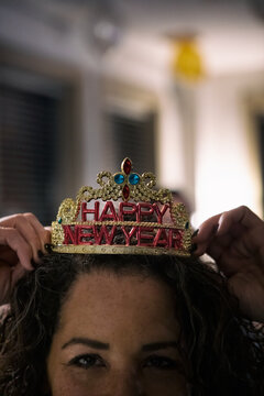 NYE: Woman Looks At Camera While Holding Party Crown