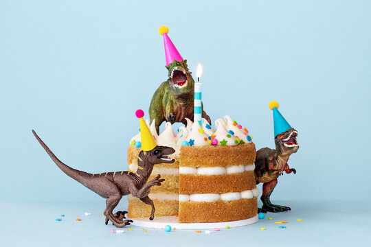Dinosaurs eating a birthday cake