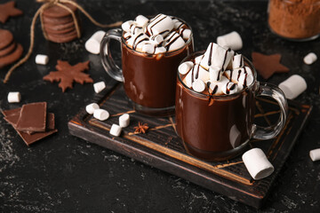 Glass cups of tasty hot chocolate with marshmallows on black background