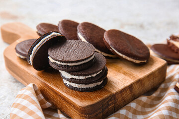 Obraz na płótnie Canvas Board with tasty chocolate cookies on table, closeup
