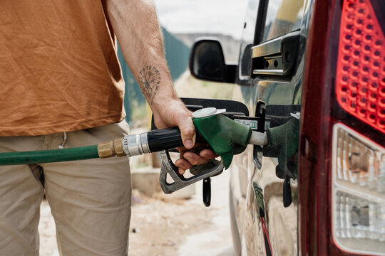 Close-up of Man refilling the fuel  tank in gas station