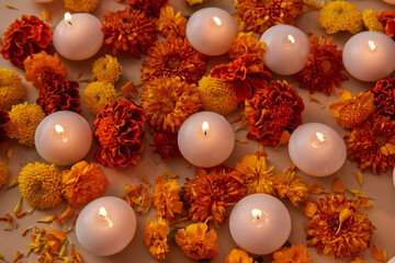 Blooming flowers and candles with flame