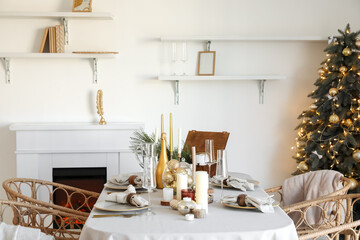 Dining table with setting for Christmas celebration in festive room