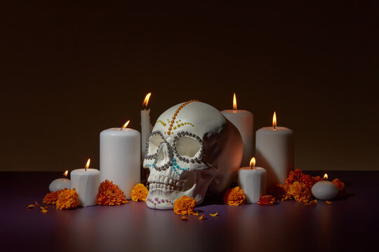 Skull with candles and flowers