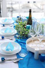 Dining table with beautiful setting for Christmas celebration and blank cards in room
