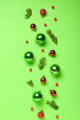 Composition with fir branches, berries and Christmas balls on green background