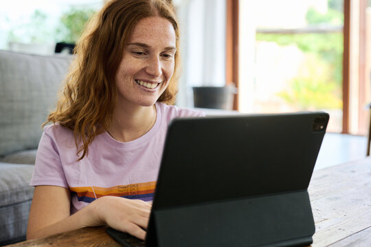 Cheerful Woman With Ipad Pro At Home