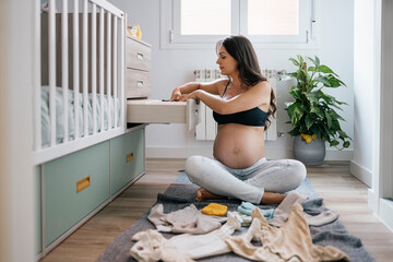 Portrait of pregnant woman at home