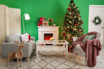 Interior of living room with fireplace, big Christmas tree and green wall
