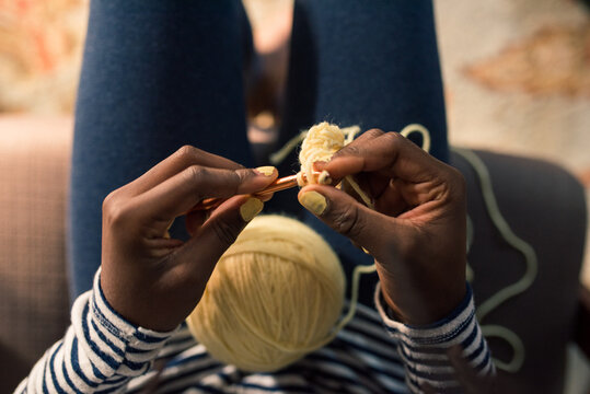 Top view of a black girl crocheting