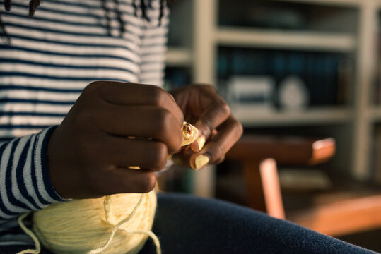 Close up of an African American girl's hands crocheting