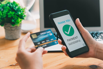 Hands holding credit card and using smartphone. Online shopping concept.