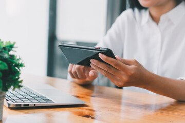 Close up Businessman using calculator for calculating finance, tax, accounting, statistics and analytical research concept.