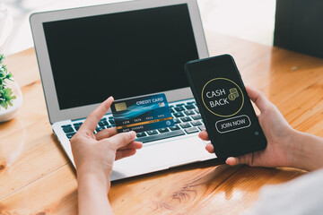 Woman taking benefit of cash back using smart phone, shopping and money refund concept. Close up...