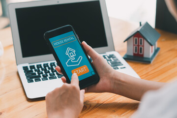 man searching for apartment on rental property website via smartphone, closeup